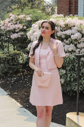 a lady in a ink vest dress and a blazer